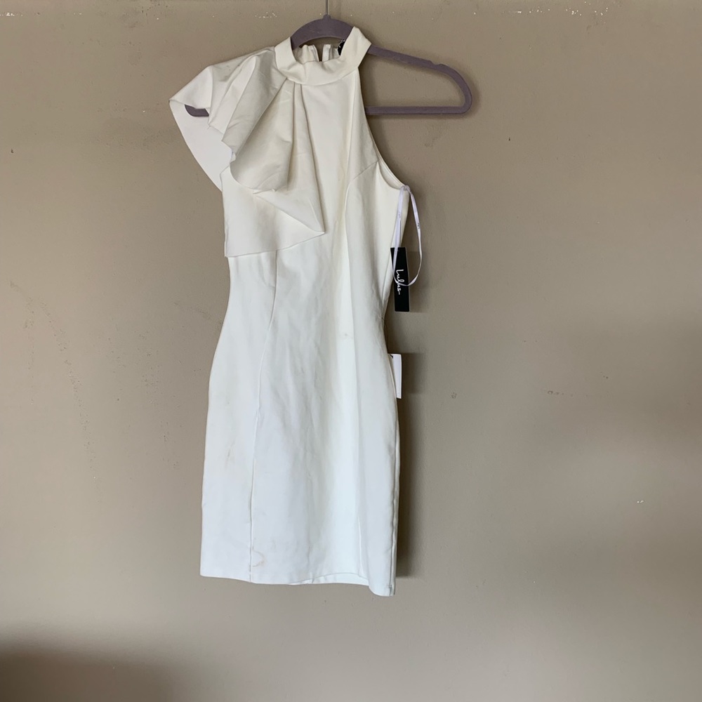 Ivory dress with shoulder ruffle.